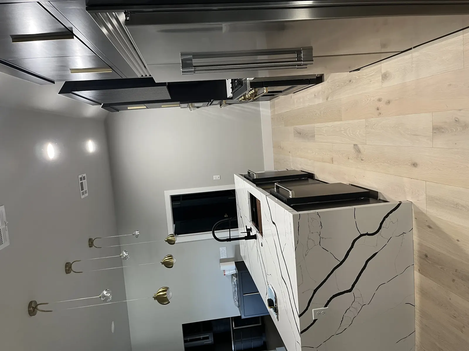 Remodeled kitchen with waterfall island sink and modern cabinetry