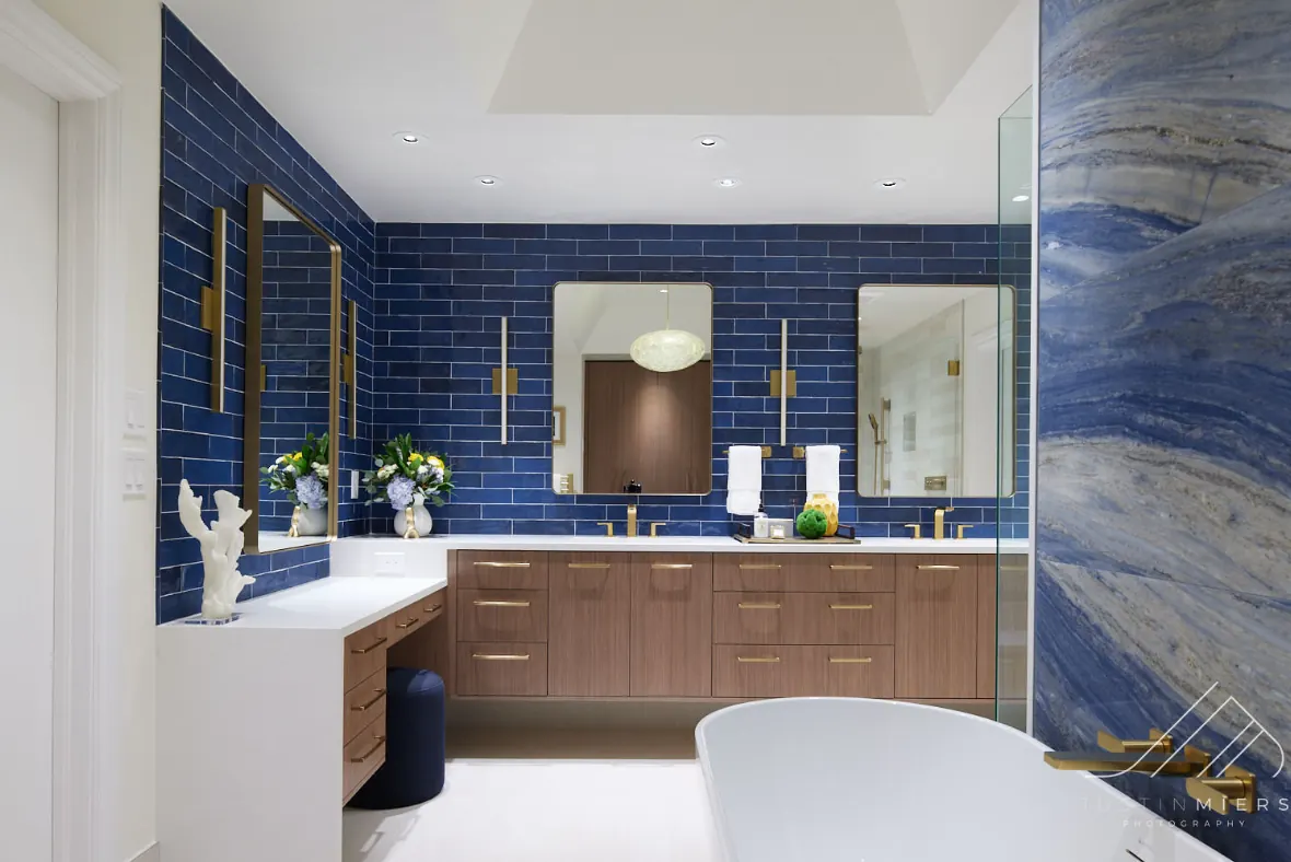 Custom shower with brass fixtures and built-in bench in an Oklahoma City bathroom remodel